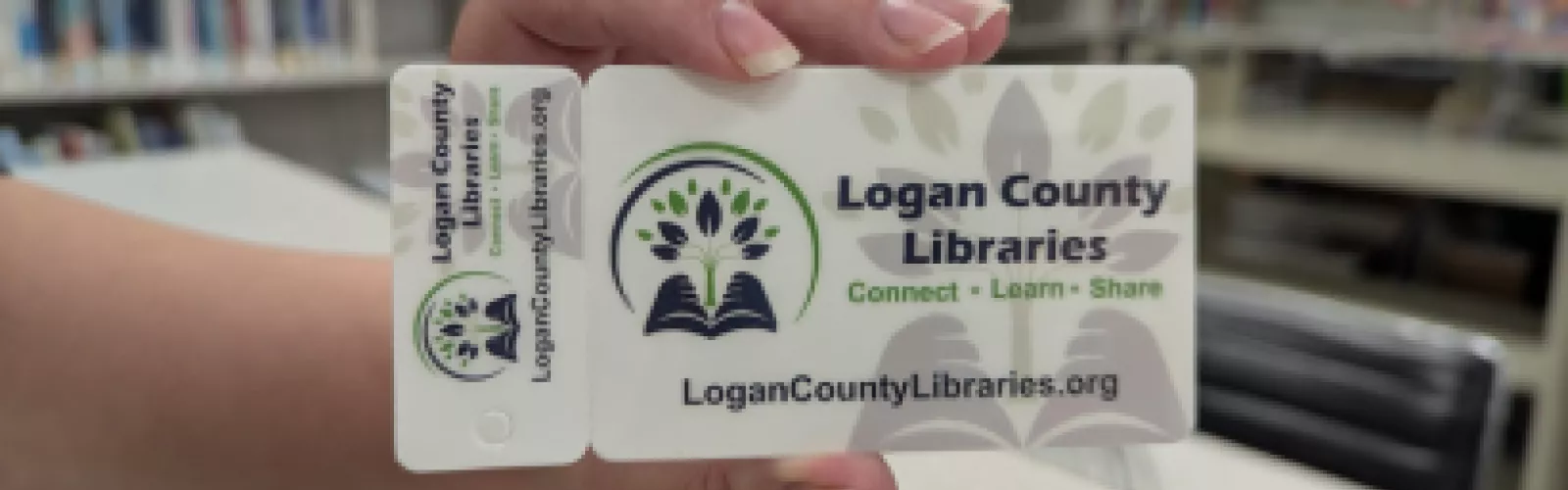 hand holding a library card